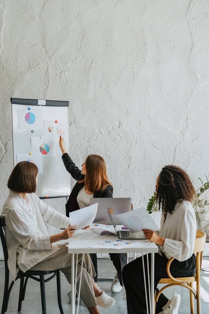 Three Women Discussing and Working Together